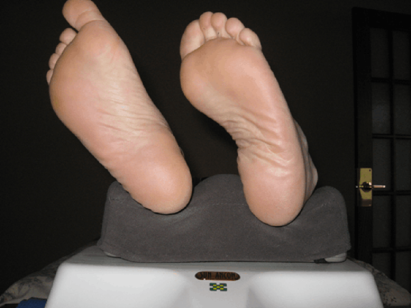 Feet on the Oxygen Massage Exerciser device